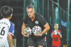 French coach kicks the ball in for Sanya youth soccer